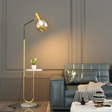 Contemporary Gold Globe Floor Lamp with Marble Storage Image - 3