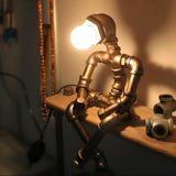 Creative Industrial Robot Warm Light Bronze Table Lamp Image - 1