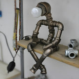 Creative Industrial Robot Warm Light Bronze Table Lamp Image - 2