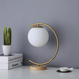 Elegant Simple Glass Globe Curved Metal Table Lamp Image - 12