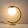 Elegant Simple Glass Globe Curved Metal Table Lamp Image - 2