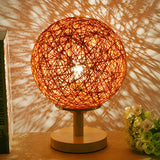 Hand-Woven Rattan Global Shade Wooden Base Table Lamp Image - 1