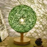 Hand-Woven Rattan Global Shade Wooden Base Table Lamp Image - 2