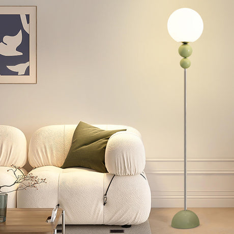 Minimalist Stacked Green Accents and Globe Floor Lamp Image - 1