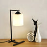 Minimalist White Cylinder Shade Black Base Table Lamp Image - 1