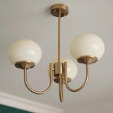 Modern 3-Light Brass Chandelier White Glass Globes Image - 1