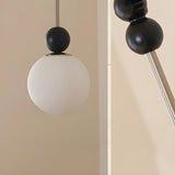 Modern Black Matte White Glass Globe Pendant Light Image - 9