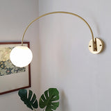 Simplistic Globe Glass Shade Gold Arc Wall Sconce Image - 1